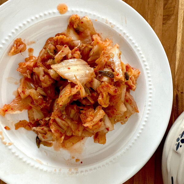 1 cup of store-bought kimchi on a white plate.