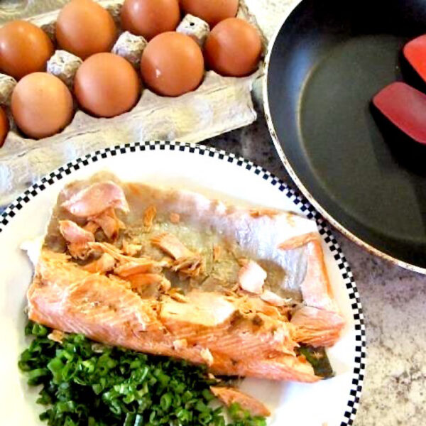 Pre-cooked salmon and eggs to use in salmon omelet (with a side of sauteed greens).