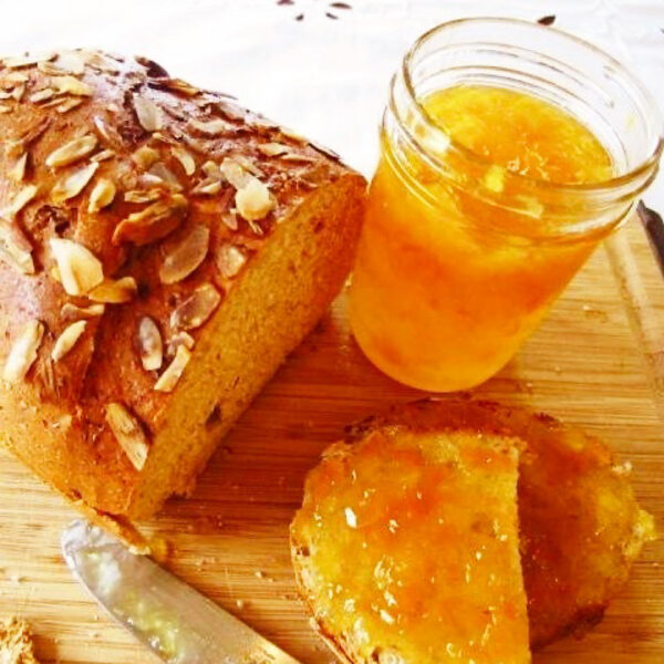 Rustic bread with meyer lemon marmalade spread on toast and in a jar.