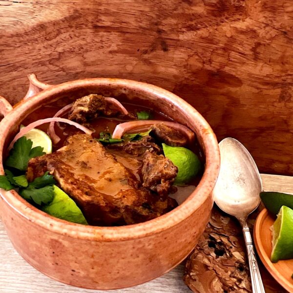 Bowl of birria stew with consomme (Birria de Res Con Consome).