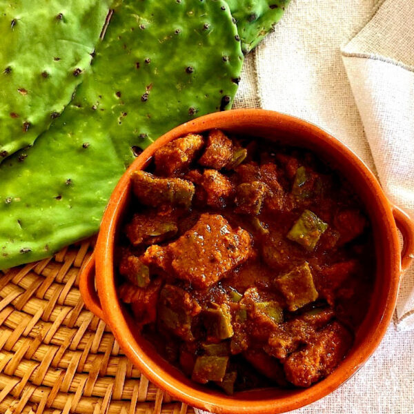 Bowl of Chile Colorado with cactus paddles (aka nopales)