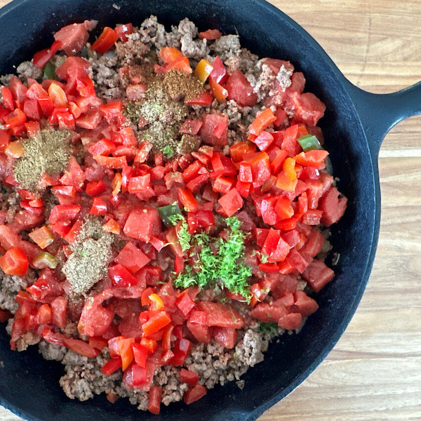 Skillet with mixture of chorizo, onions, tomatoes, peppers and spices.