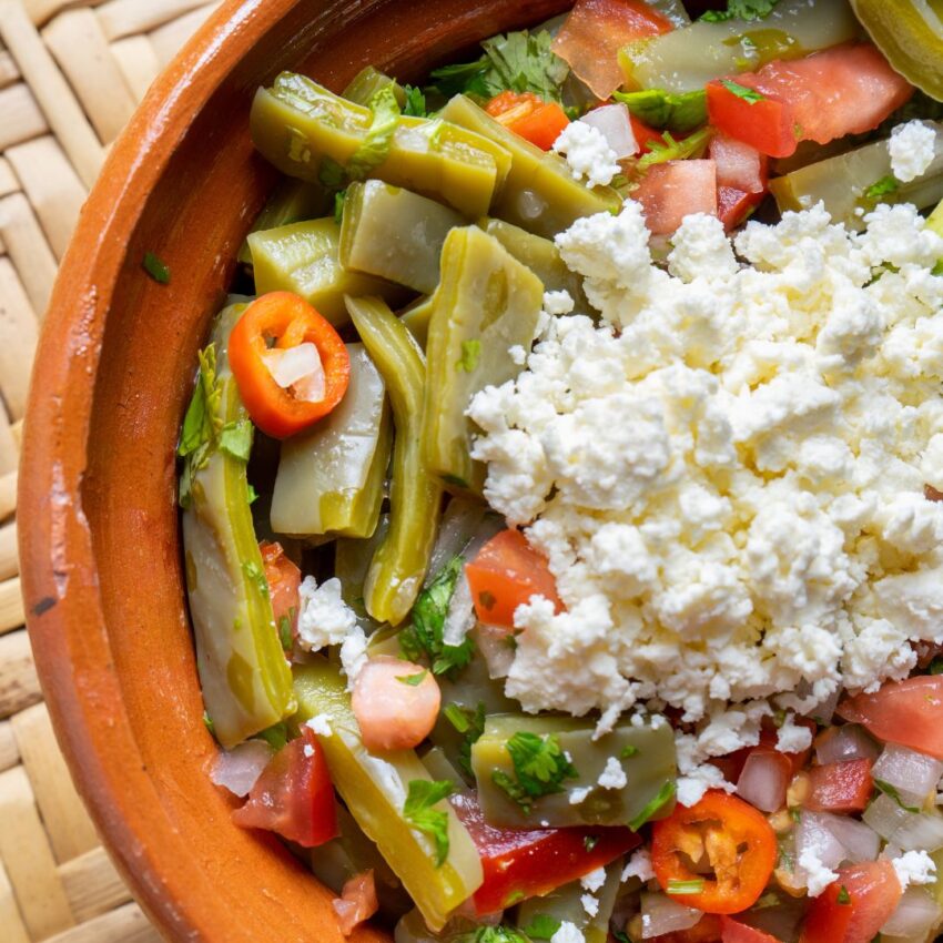 Mexican salad of nopales, tomatoes and crumbled cheese.