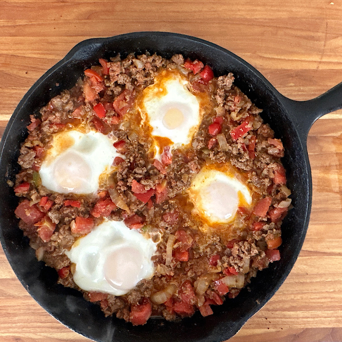 Finished dish of chorizo and eggs in a skillet.