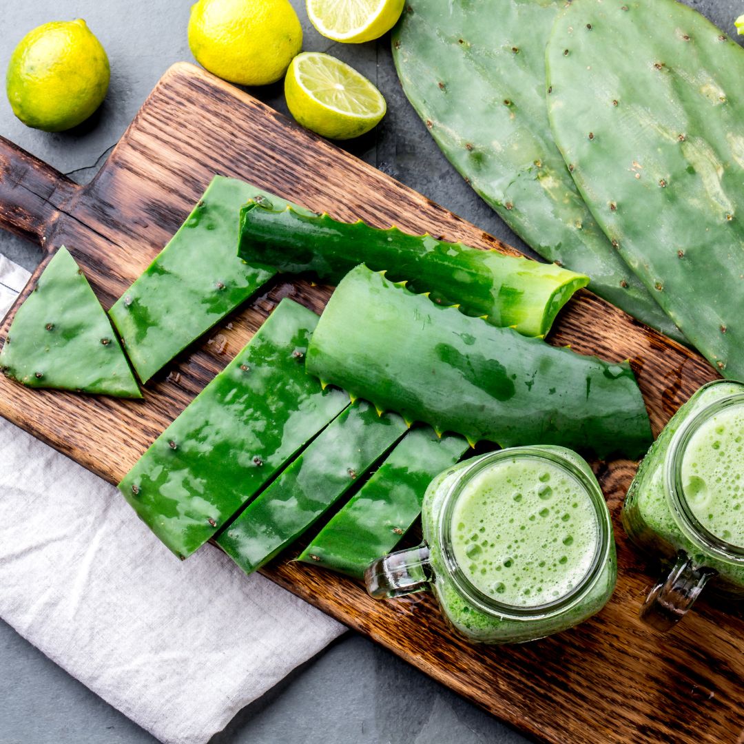 Cactus paddles (Nopales) with thorns removed and a side of cactus juice and lemons on the side.