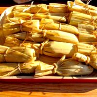 Plate of tied tamales ready for cooking