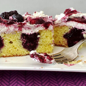 Side view of blueberry blackberry poke cake.