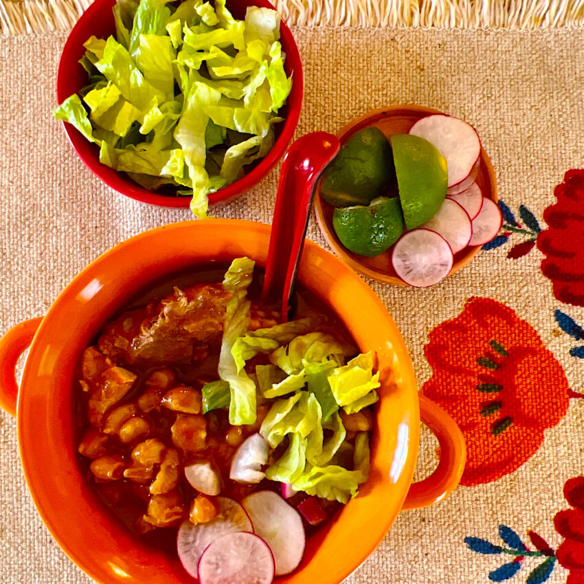 Bowl of Mexican pork pozole with hominy.