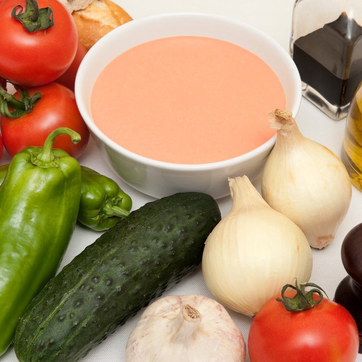 Ingredients for traditional gazpacho, including cucumber, pepper, tomatoes, onions, oil, vinegar and garlic.