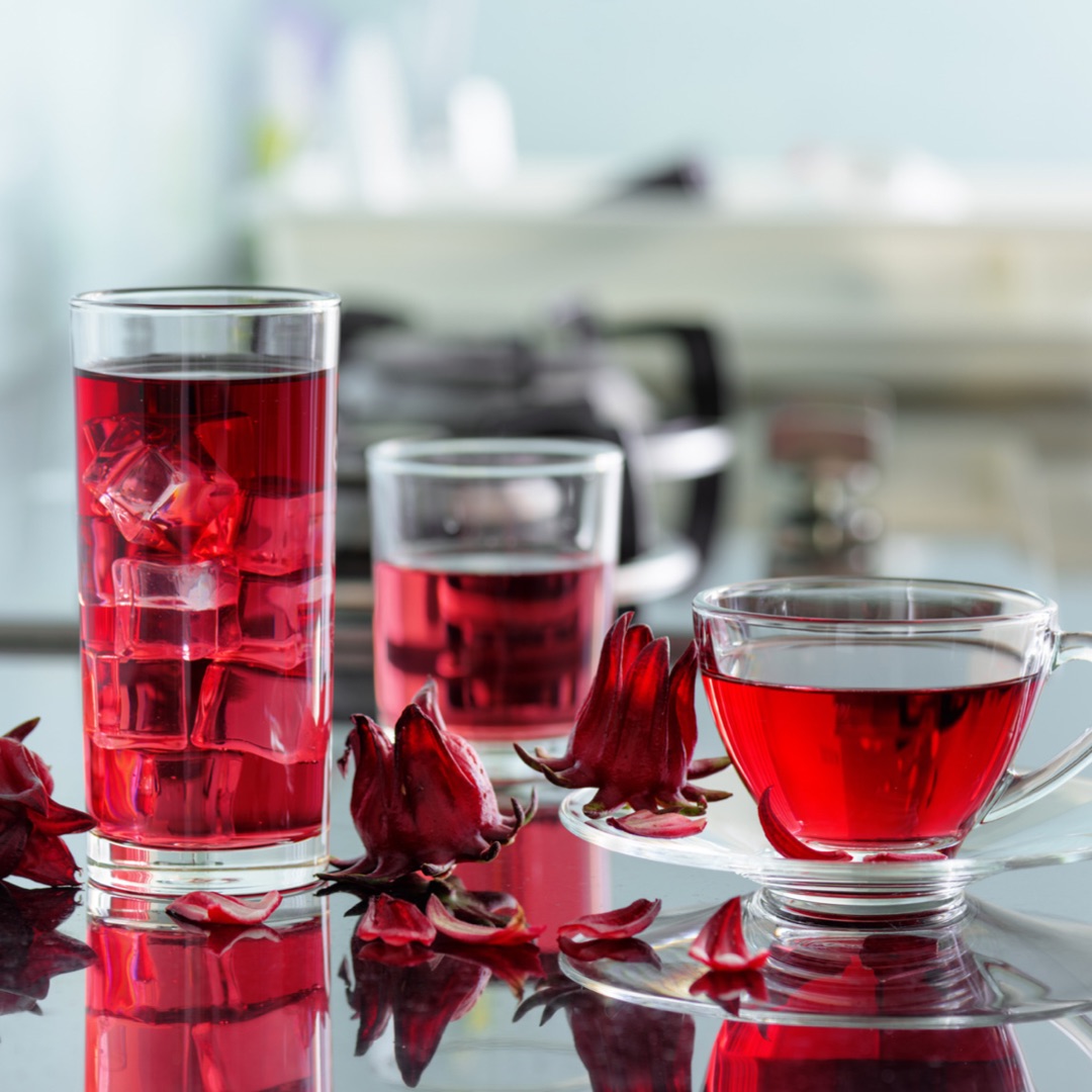 Several different drinks made with hibiscus flowers.