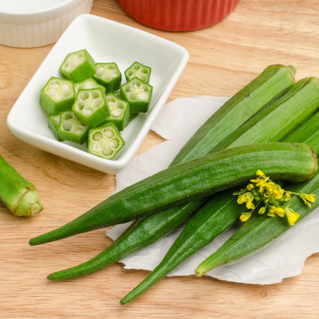 Okra pods and a side dish of sliced okra.
