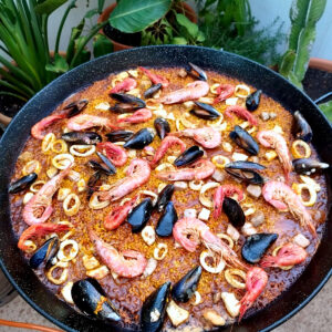 Paella de Mariscos being made outdoors in Spain.