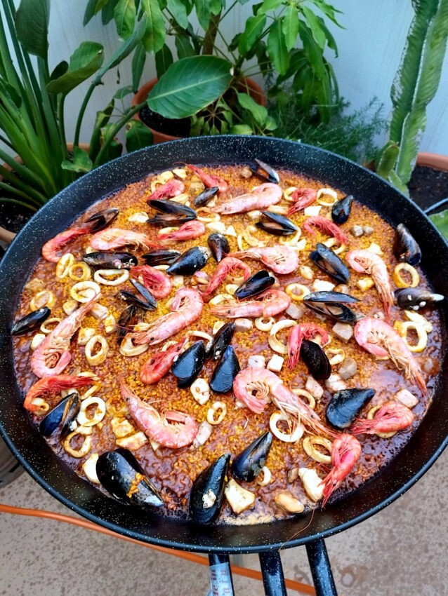 Paella de Mariscos being made outdoors in Spain.