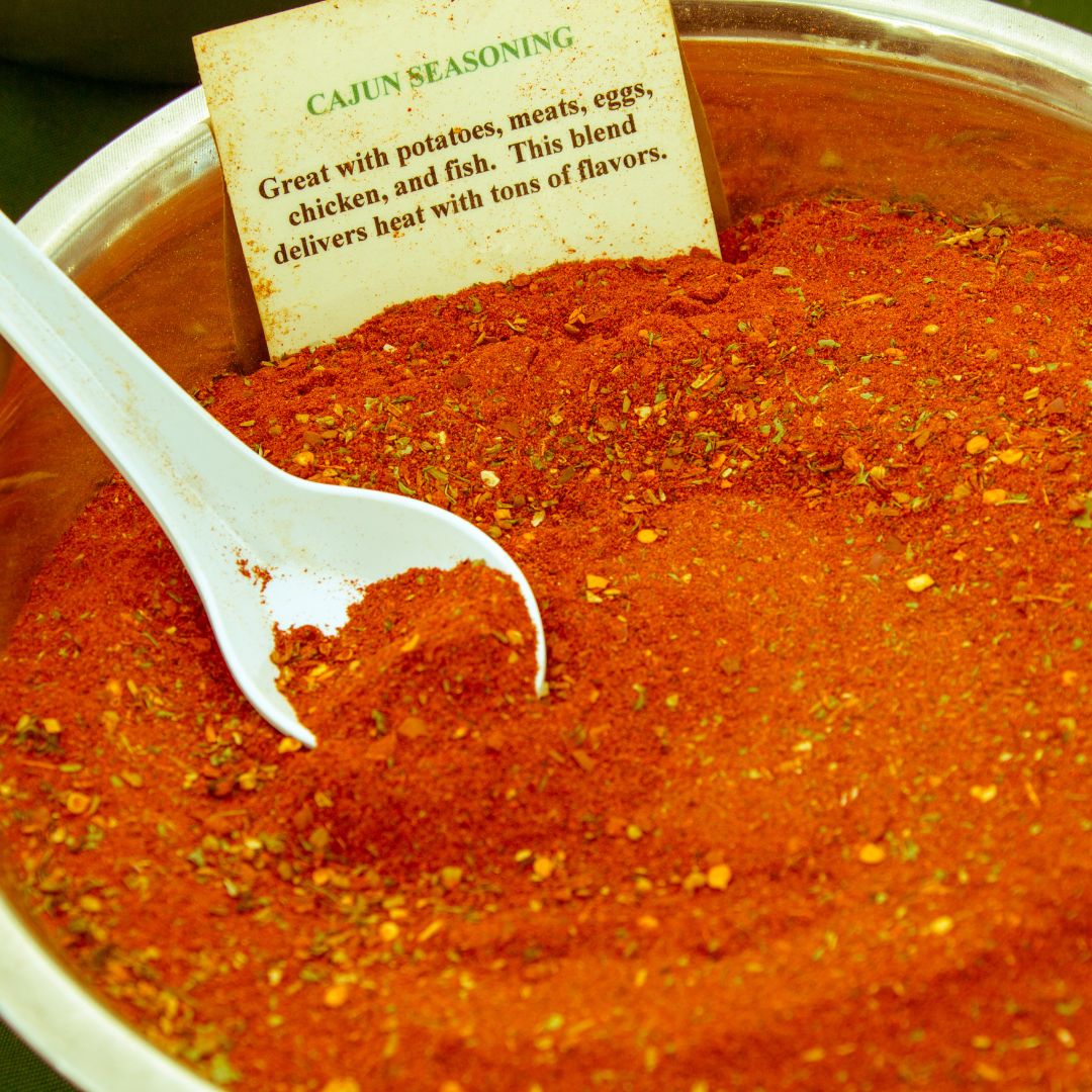 Cajun powdered spice blend in a bowl with white spoon.