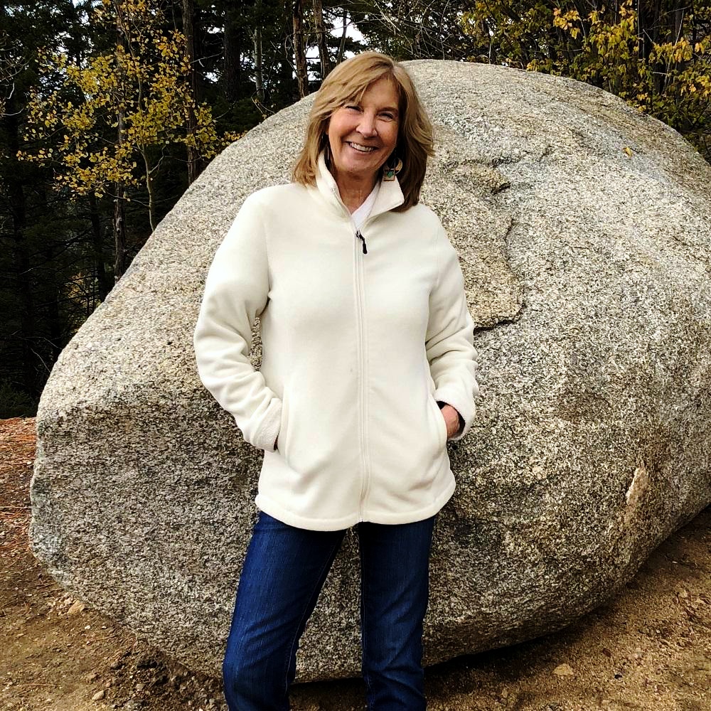 Dorothy Stainbrook in front of large boulder in Arizona.