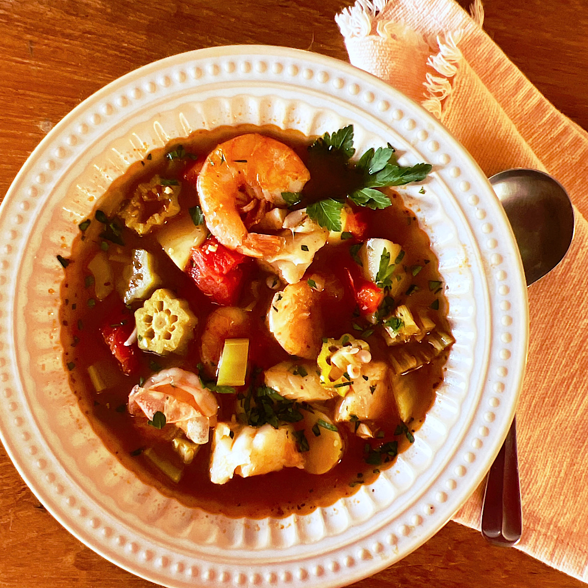 Creole okra and seafood stew or gumbo in a white bowl.