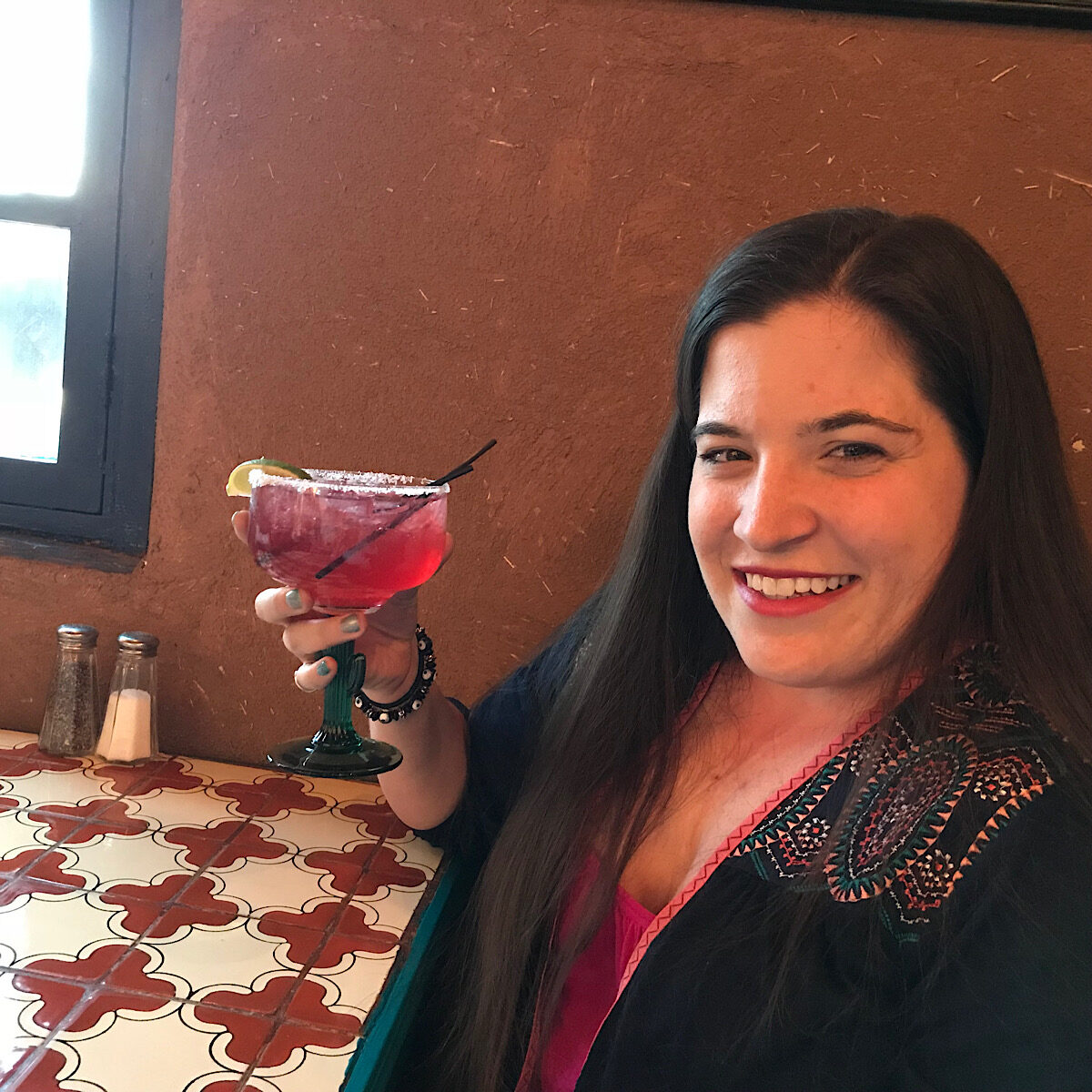 Tesla Stainbrook, daughter and Farm to Jar partner, holding a cocktail.