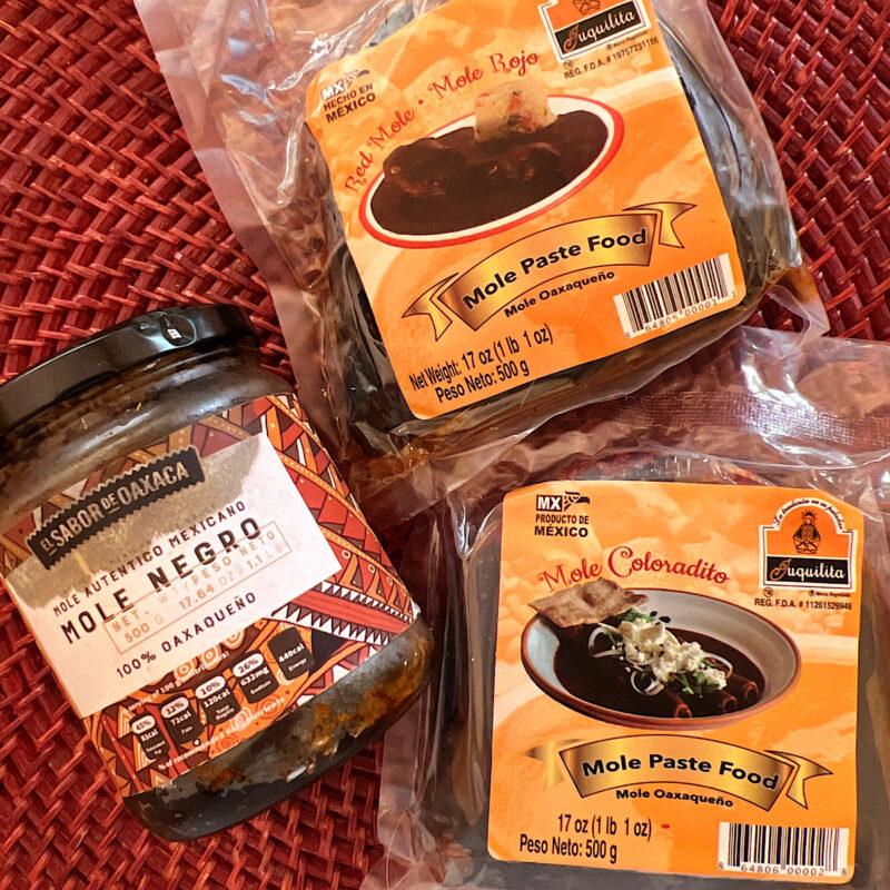 1 jar and 2 packages of prepared mole pastes: negro, rojo and coloradito.