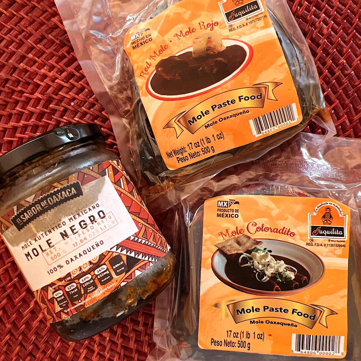 1 jar and 2 packages of prepared mole pastes: negro, rojo and coloradito.