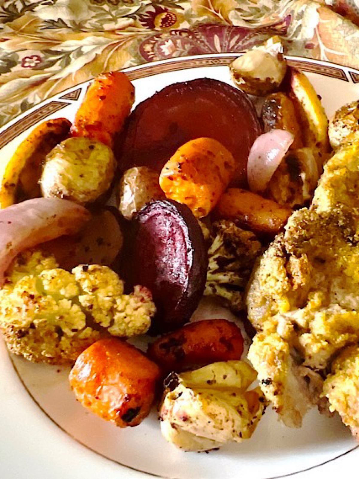Medley of roasted root vegetables on a plate from a sheet pan method of cooking.