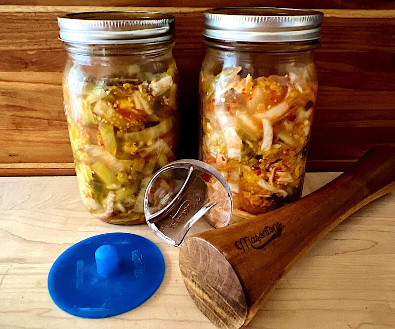 2 jars of kimchi and the fermenting tools needed to make it.