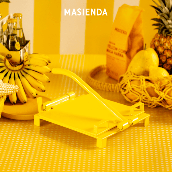 Yellow tortilla press on yellow background from Masienda.