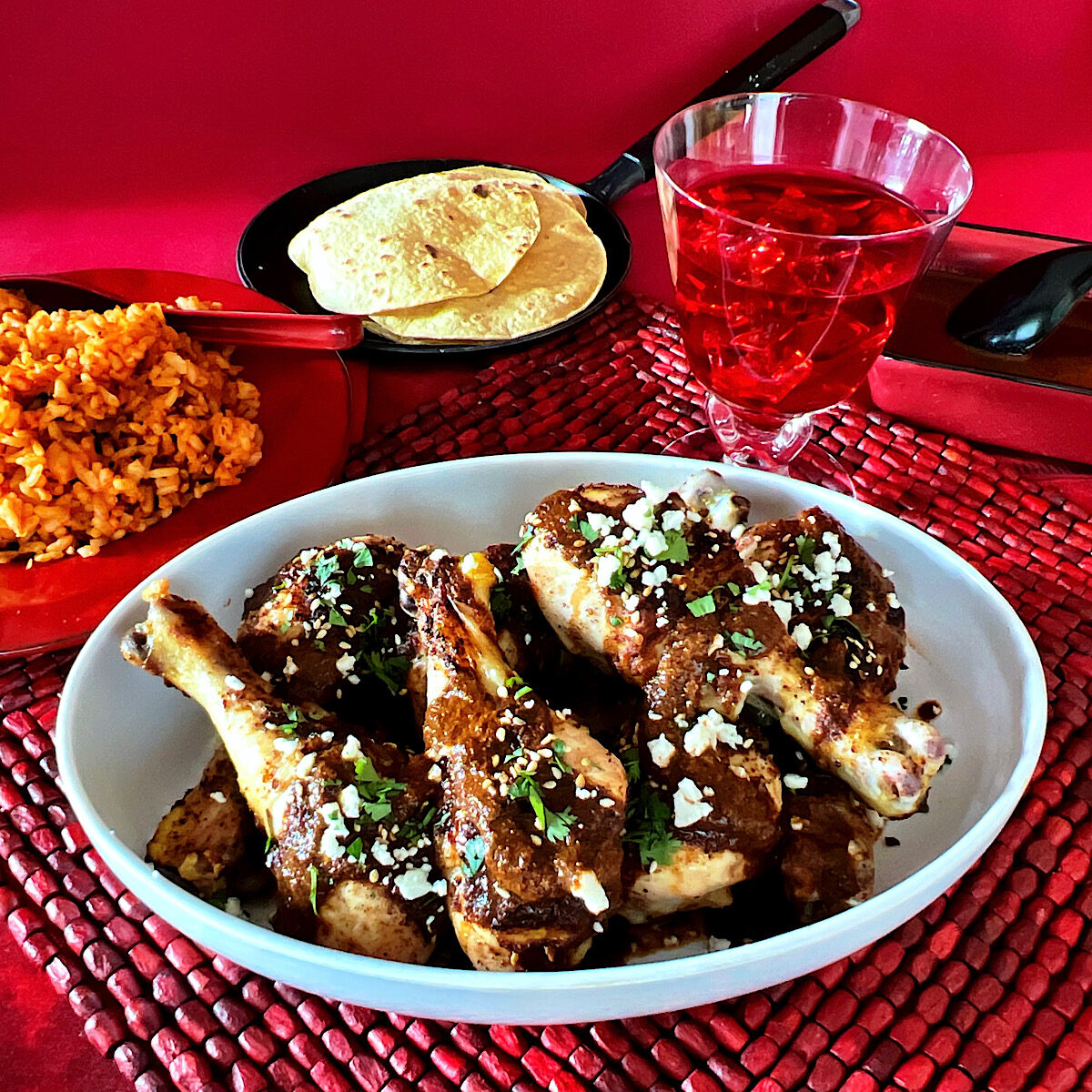 Chicken legs with mole rojo sauce and red rice and hibiscus tea.