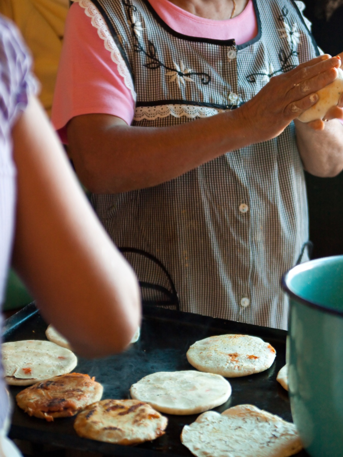 Mexican cook making tortillas.