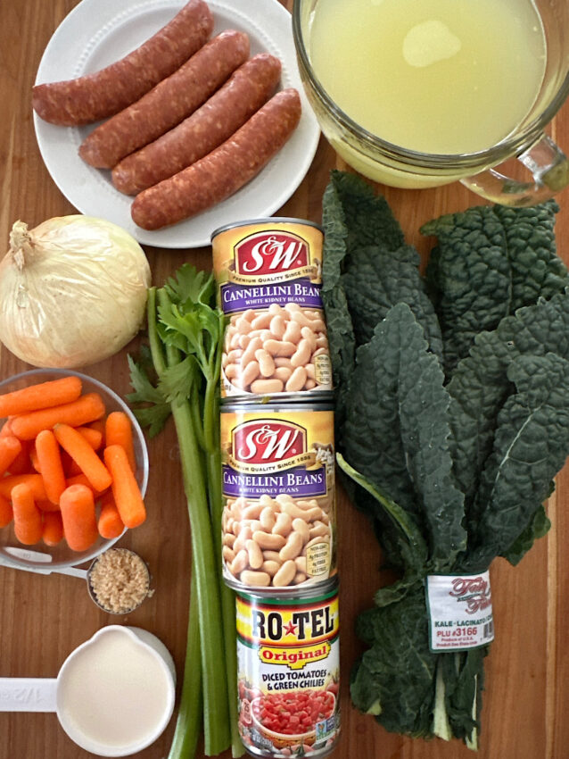 Ingredients for Italian white bean and kale stew laid out on a cutting board.