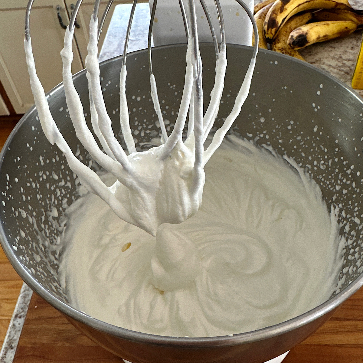 Stand mixer with whipped cream beat into soft peaks.