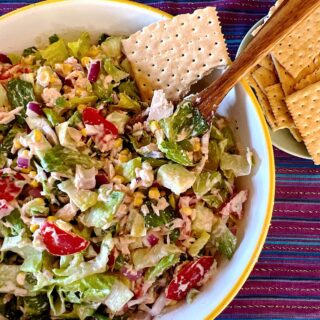 Mexican tuna chopped salad in a bowl with saltine crackers on the side.