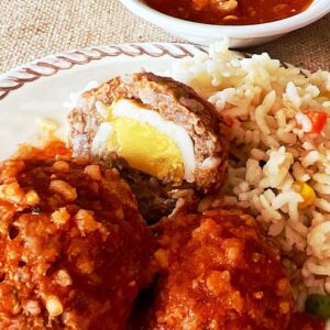 Albondigas en Salsa (Mexican meatballs) showing closeup of egg stuffing.