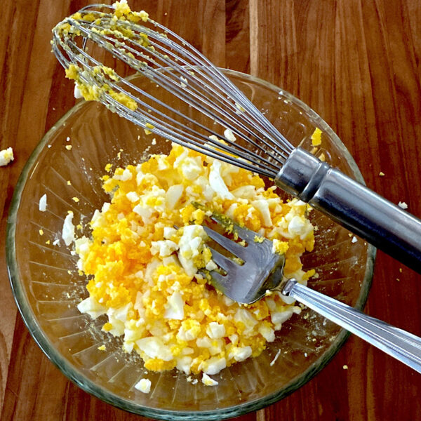 Glass bowl of chopped eggs for an egg salad sandwich