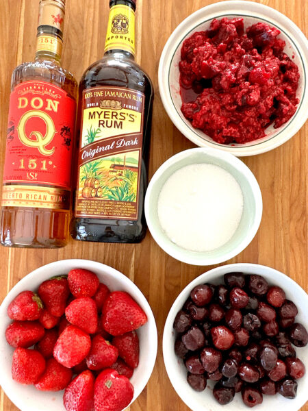 Ingredients for making rumtopf: rum, berries and sugar.