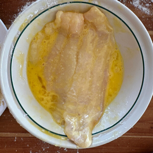 Catfish filet coated in lightly beaten egg.