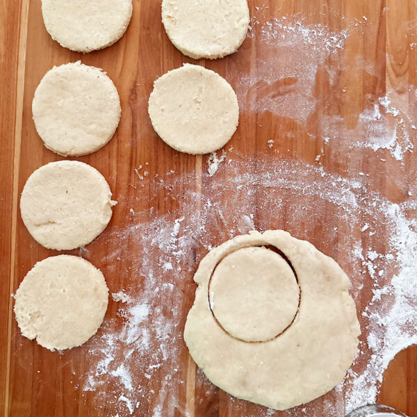 Cut out biscuits on a floured cutting board.