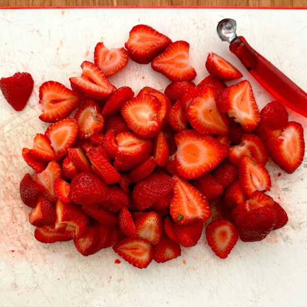 One pound of sliced strawberries with strawberry holler.