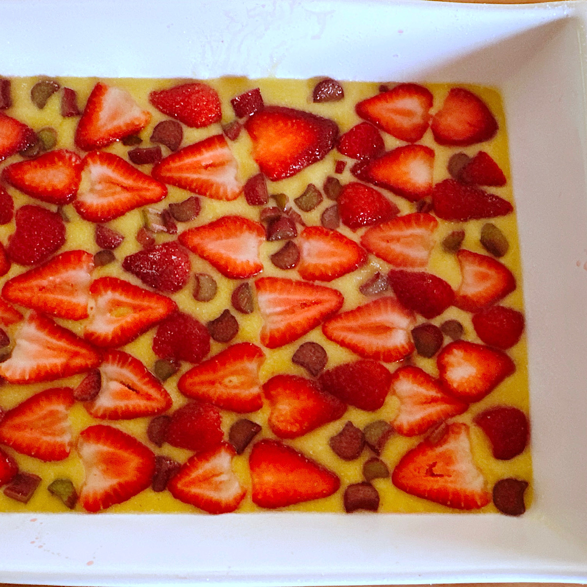 Strawberry rhubarb sheet cake before baking.