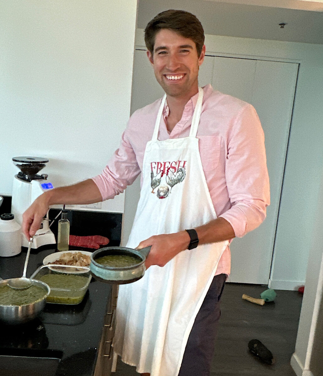 The cook dishing up a pot of chicken pipian.