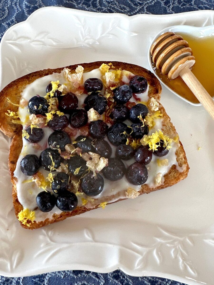 Blueberry toast with lemon yogurt, lemon zest and candied ginger