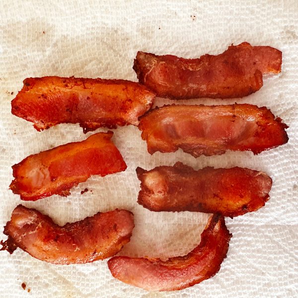 Crispy bacon draining on paper towels