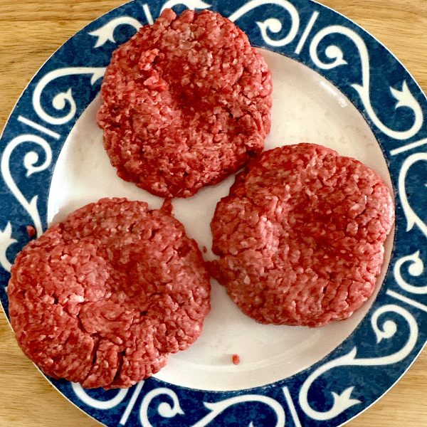 Burger patties with thumbprint in the middle for cooking without shrinkage.