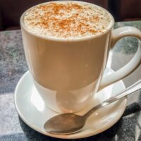 Chai tea latte bought in a US restaurant in a white cup.