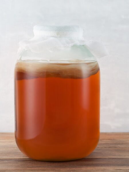Chai tea simple syrup in a large glass jug.