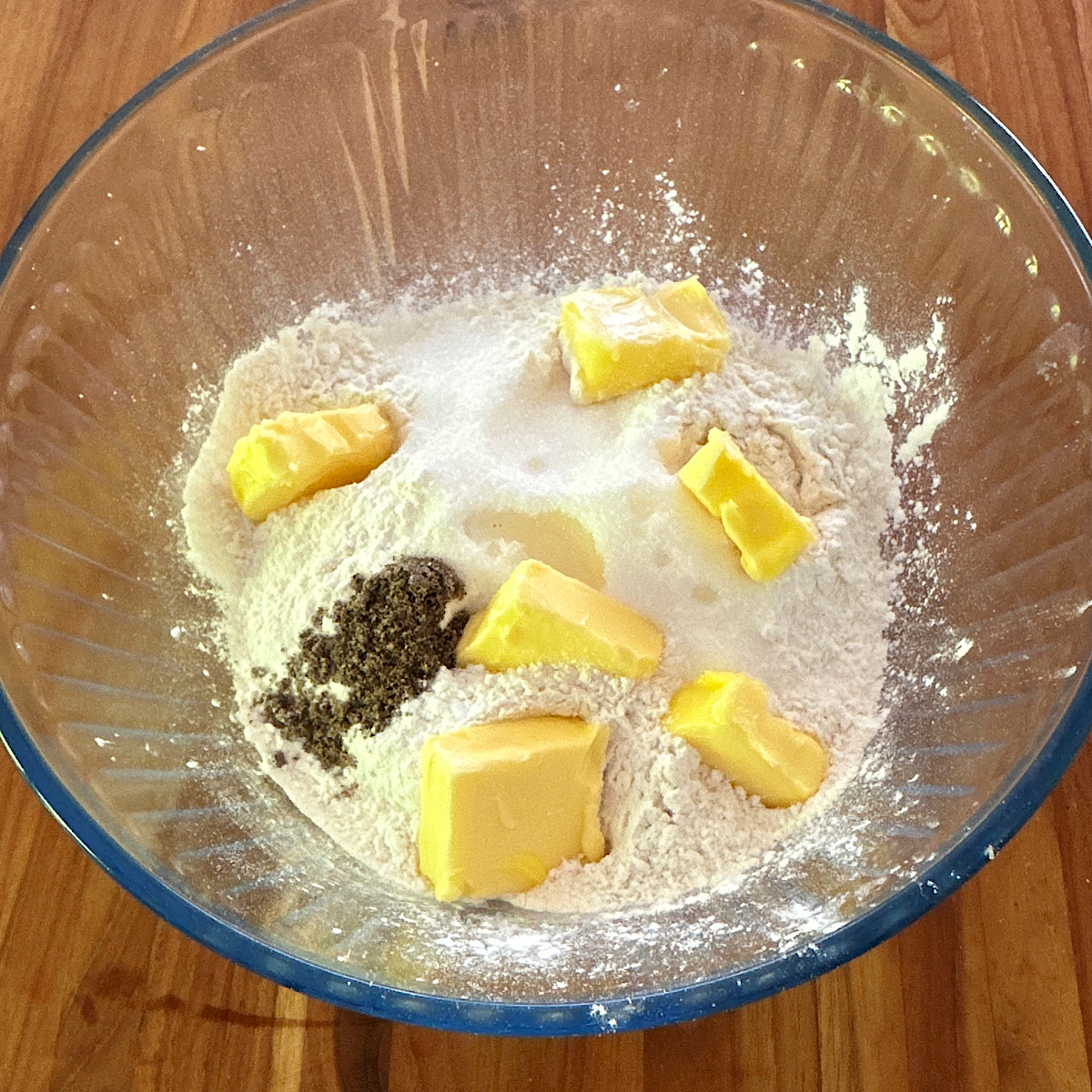 Bowl with dry ingredients and butter in prep for raspberry scones