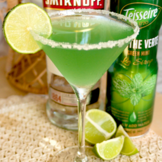 Green tea martini with lime slice garnish