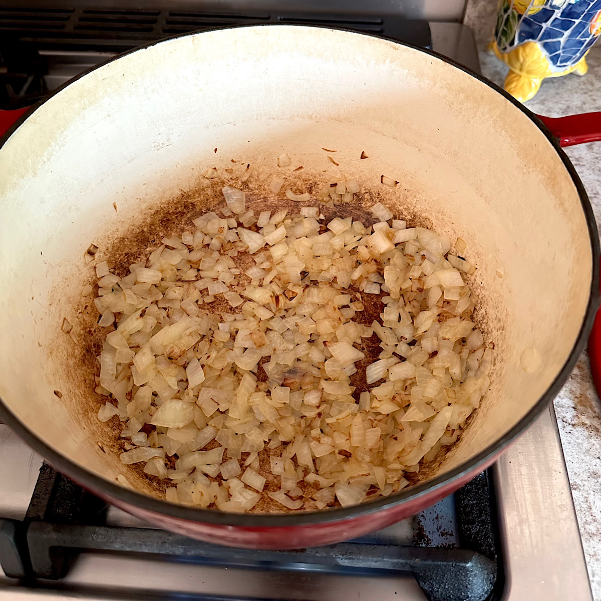 Chopped onions caramelizing in a dutch oven.