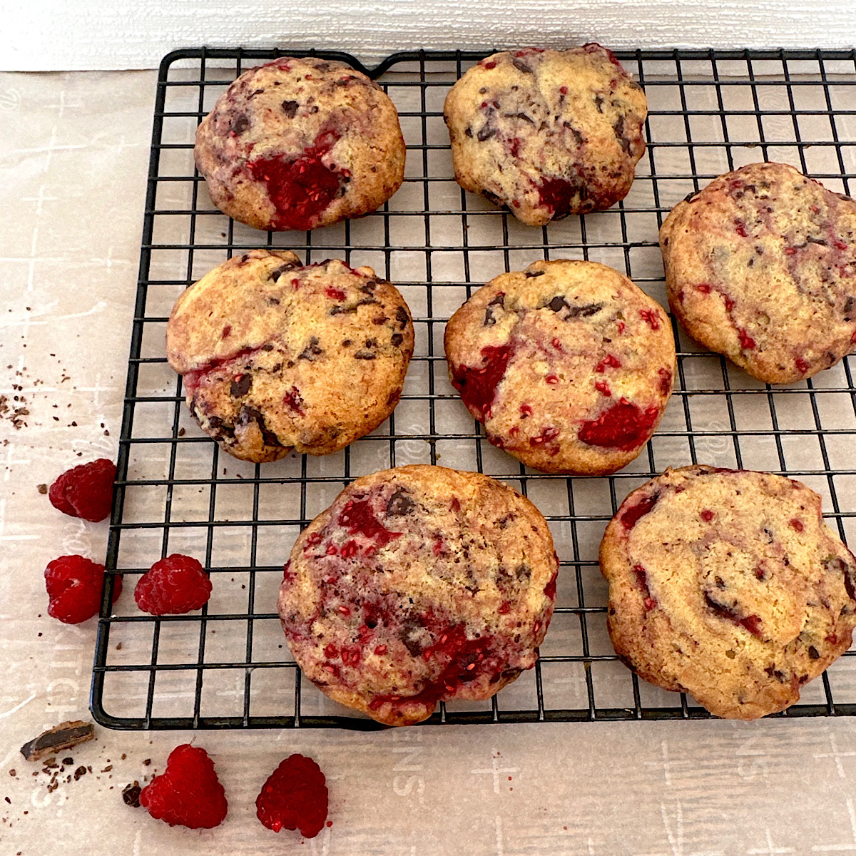 Baked raspberry chocolate cookies on a baking rack