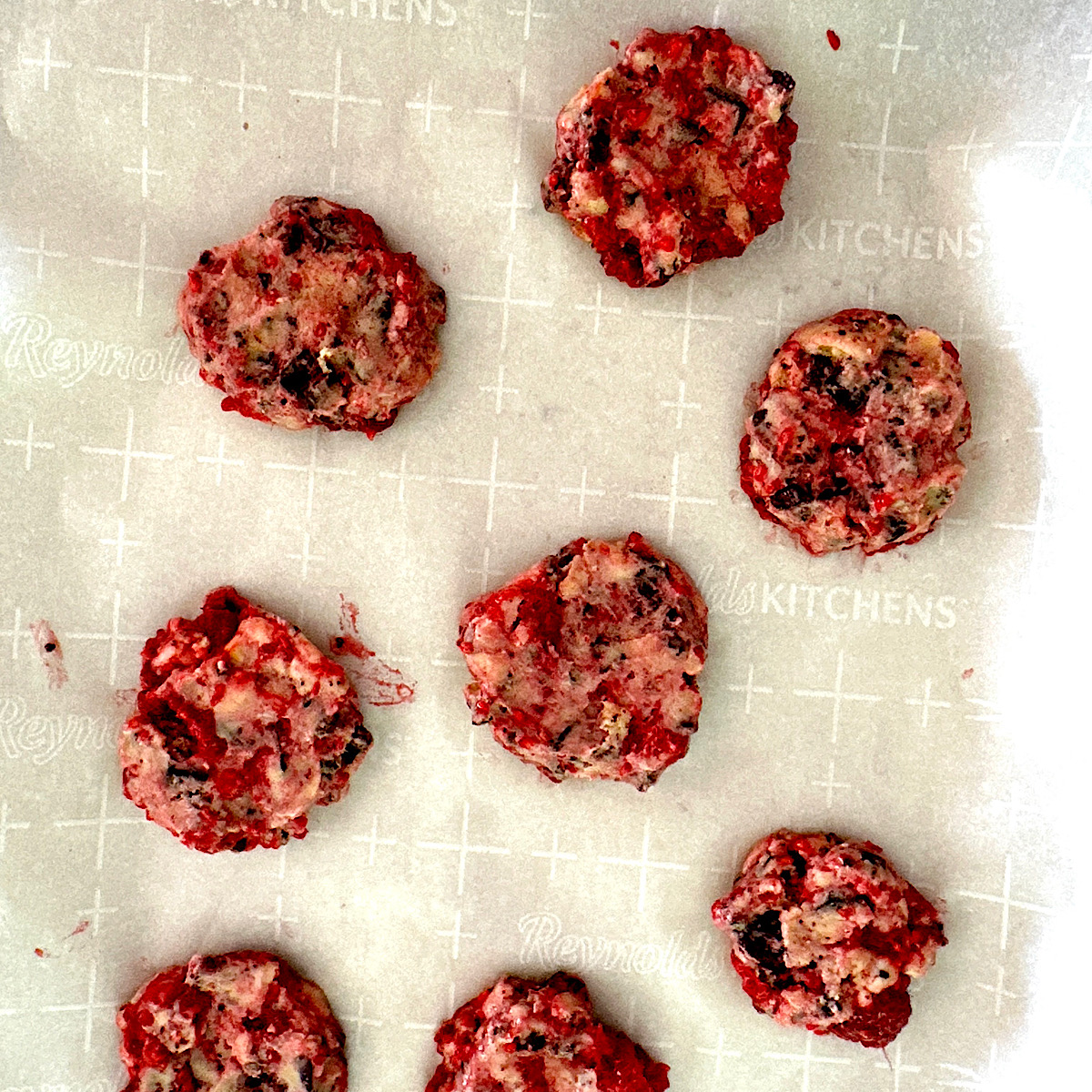 Raspberry chocolate cookie dough on baking sheet