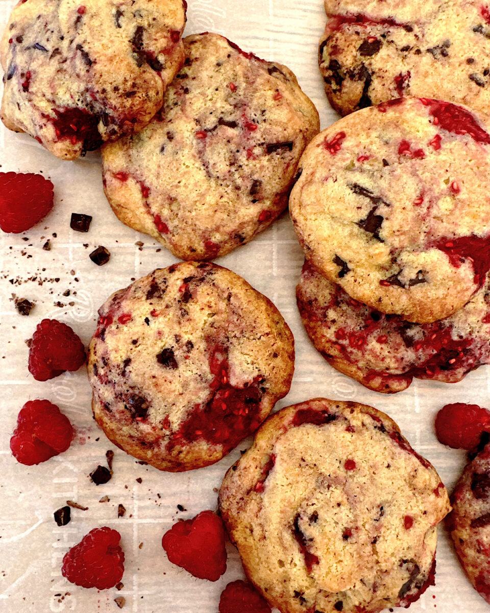 Raspberry dark chocolate cookies on parchment paper